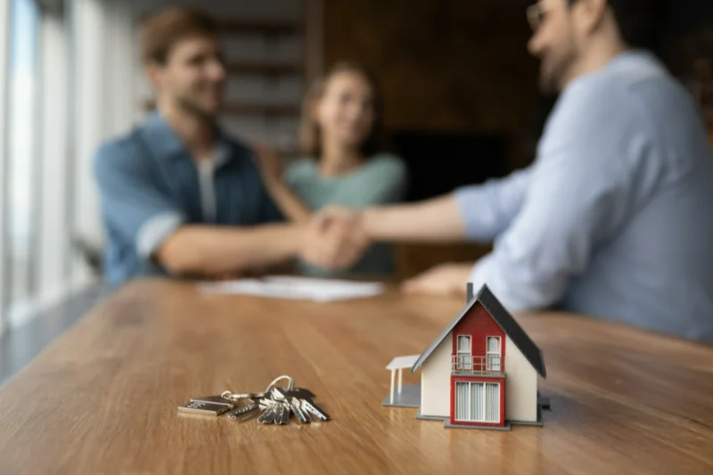 Couple shaking hands with a professional.