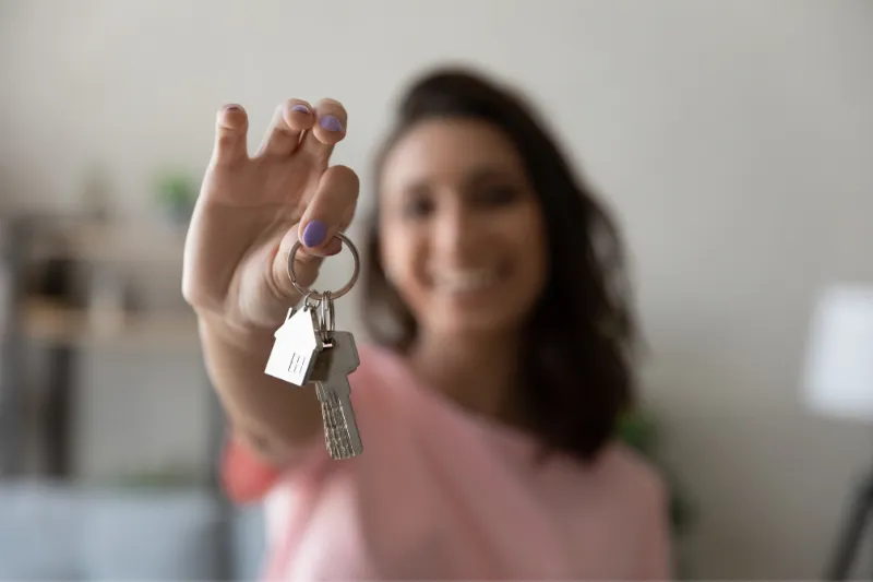 First time home buyer with keys in her hand.